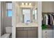 Modern bathroom with quartz countertop, grey vanity and a view into a closet space at 6433 Farness St, Las Vegas, NV 89135