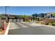 Community entrance featuring a gated entrance with stone and brick pillars surrounded by desert landscaping at 6433 Farness St, Las Vegas, NV 89135
