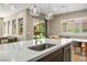 Kitchen island with sink overlooks the dining area and backyard, offering a view and open floorplan at 6433 Farness St, Las Vegas, NV 89135