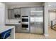 Modern kitchen featuring stainless steel appliances, gray cabinetry, and adjacent staircase at 6433 Farness St, Las Vegas, NV 89135