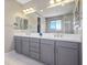 Elegant main bathroom featuring a double sink vanity and large mirrors at 6433 Farness St, Las Vegas, NV 89135