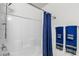 Bright bathroom featuring a shower and coordinating blue towels at 6953 Midnight Bronze St, North Las Vegas, NV 89086
