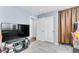 Comfortable second bedroom featuring a TV and arcade game at 6953 Midnight Bronze St, North Las Vegas, NV 89086