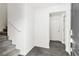 Bright entryway featuring gray wood-look floors and carpeted stairs leading to the upper level at 6953 Midnight Bronze St, North Las Vegas, NV 89086