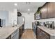 Modern kitchen featuring stainless steel appliances, granite counters, and ample cabinet space at 6953 Midnight Bronze St, North Las Vegas, NV 89086