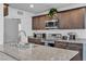 Well-equipped kitchen featuring granite countertops, stainless steel appliances, and sleek wood cabinets at 6953 Midnight Bronze St, North Las Vegas, NV 89086