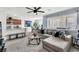 Bright and open living space with a kitchen, a comfortable sectional sofa, and natural light at 6953 Midnight Bronze St, North Las Vegas, NV 89086