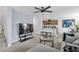 Inviting living area with a view of the kitchen, plush carpeting, and ample seating at 6953 Midnight Bronze St, North Las Vegas, NV 89086