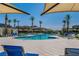 Resort-style community pool featuring lounge chairs and palm trees at 6953 Midnight Bronze St, North Las Vegas, NV 89086