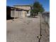 Basic two-story home with exterior staircase, minimal landscaping, and fenced perimeter at 709 G St, Las Vegas, NV 89106