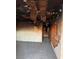 Fire damaged living room featuring a tiled floor, exposed studs, and missing ceiling at 709 G St, Las Vegas, NV 89106