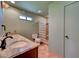The bathroom features a double sink, granite counters, and a large glass block shower at 7100 Carrondale Way, Las Vegas, NV 89128