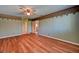 Comfortable bedroom with wood floors, doors, and ceiling fan is awaiting your personal touches at 7100 Carrondale Way, Las Vegas, NV 89128
