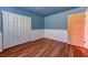Quaint bedroom featuring hardwood floors, plantation shutters, and large wardrobe at 7100 Carrondale Way, Las Vegas, NV 89128