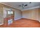 Cozy bedroom with hardwood floors, ceiling fan, crown molding, and mirrored closet doors at 7100 Carrondale Way, Las Vegas, NV 89128