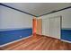 This bedroom offers plenty of space, wood floors, and closet with folding doors at 7100 Carrondale Way, Las Vegas, NV 89128