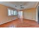 Bright bedroom featuring hardwood floors, ceiling fan, plantation shutters and access to the backyard at 7100 Carrondale Way, Las Vegas, NV 89128