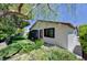 Well-maintained home with green grass, foliage, stone, and mature trees at 7100 Carrondale Way, Las Vegas, NV 89128