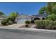 Charming single-story home featuring desert landscaping, a two-car garage, and solar panels for energy efficiency at 7100 Carrondale Way, Las Vegas, NV 89128