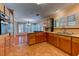 Bright open kitchen featuring wood cabinets, an island, and stainless steel appliances at 7100 Carrondale Way, Las Vegas, NV 89128