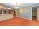 Open living area featuring hardwood floors, modern lighting, and an open kitchen area at 7100 Carrondale Way, Las Vegas, NV 89128