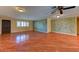 Spacious living room featuring hard wood floors, natural lighting, and decorative interior painting at 7100 Carrondale Way, Las Vegas, NV 89128
