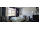A calming bedroom featuring a comfortable bed and a window with natural light at 7395 Howell Mill Ct, Las Vegas, NV 89113