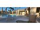 Resort-style community pool featuring covered seating areas, well-maintained landscaping, and clear blue water at 7395 Howell Mill Ct, Las Vegas, NV 89113