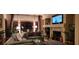 Inviting living room with a cozy fireplace, large windows, and comfortable seating at 7395 Howell Mill Ct, Las Vegas, NV 89113