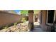 Landscaped side yard with plants and rock ground covering at 7395 Howell Mill Ct, Las Vegas, NV 89113