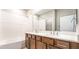 Bathroom with dual sink vanity and shower over tub with a tiled surround at 769 Cloud Creek St, Henderson, NV 89011