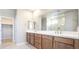 Bathroom with a dual sink vanity and a large mirror, great natural light at 769 Cloud Creek St, Henderson, NV 89011