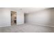 Large open bedroom with neutral walls and carpet and views of the ensuite bathroom at 769 Cloud Creek St, Henderson, NV 89011