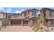 Charming two-story home with a two-car garage, stone accents, and a beautifully landscaped front yard at 769 Cloud Creek St, Henderson, NV 89011