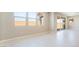 Bright and airy living room with tile floors, multiple windows, and sliding glass doors to the backyard at 769 Cloud Creek St, Henderson, NV 89011
