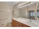 Bathroom featuring dual sinks, a large mirror, and a shower-tub combination at 7916 Lyrebird Dr, North Las Vegas, NV 89084