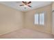 Bedroom with carpet flooring, a ceiling fan, and plantation shutters at 7916 Lyrebird Dr, North Las Vegas, NV 89084