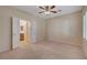 Neutral bedroom with carpet flooring and doors to an ensuite bathroom at 7916 Lyrebird Dr, North Las Vegas, NV 89084