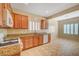 Kitchen featuring wooden cabinets, white appliances, granite counters and tile floors at 7916 Lyrebird Dr, North Las Vegas, NV 89084