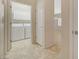 Hallway view of the laundry room with white cabinets and neutral tile at 7916 Lyrebird Dr, North Las Vegas, NV 89084