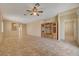 Spacious living room with tile flooring, a ceiling fan, and built-in shelving at 7916 Lyrebird Dr, North Las Vegas, NV 89084