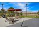 Inviting outdoor patio with comfortable seating, a shade umbrella and mountain views at 7916 Lyrebird Dr, North Las Vegas, NV 89084