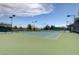 Brightly lit tennis court surrounded by lush landscaping, perfect for recreational matches at 7916 Lyrebird Dr, North Las Vegas, NV 89084