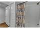 Bright bathroom features a shower-tub combination with neutral-toned shower curtain at 7950 W Flamingo Rd # 1042, Las Vegas, NV 89147
