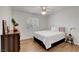 Bright, comfortable bedroom with wood-look floors, a cozy bed, and a serene view from the window at 7950 W Flamingo Rd # 1042, Las Vegas, NV 89147