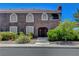 Exterior view of a two-story condo with arched windows and well-maintained landscaping at 7950 W Flamingo Rd # 1042, Las Vegas, NV 89147