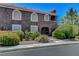 Exterior view of a two-story condo with arched windows and well-maintained landscaping at 7950 W Flamingo Rd # 1042, Las Vegas, NV 89147