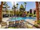 Resort-style community pool surrounded by palm trees and lounge chairs at 7950 W Flamingo Rd # 1042, Las Vegas, NV 89147