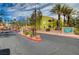 Beautiful exterior view of the community entrance with lush landscaping, palm trees and manicured flowerbeds at 7950 W Flamingo Rd # 1042, Las Vegas, NV 89147