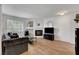 Well-lit living room with wood-style floors, a cozy fireplace, and comfortable seating for relaxing and entertaining at 7950 W Flamingo Rd # 1042, Las Vegas, NV 89147